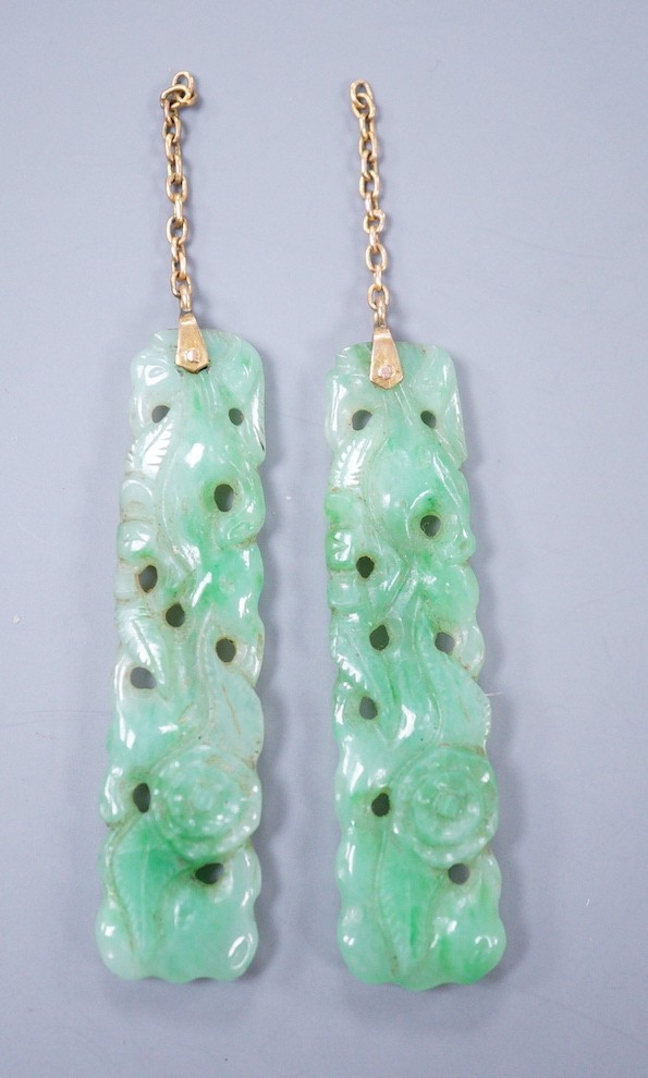 A pair of carved jade earrings, lacking mounts, 37mm.